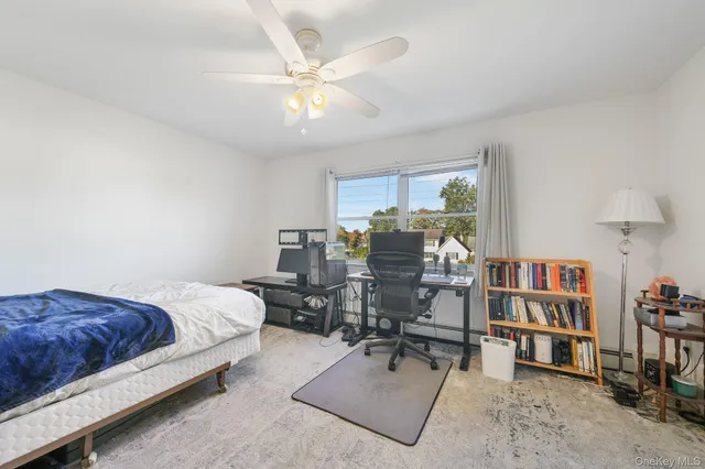 a bedroom with furniture and a book shelf