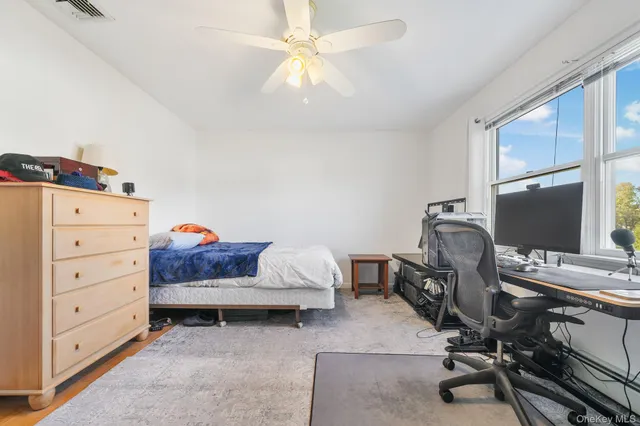 a view of a workspace with furniture and a window