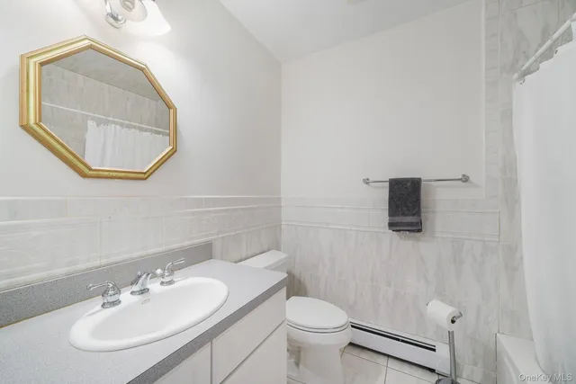 a bathroom with a sink a mirror and a toilet