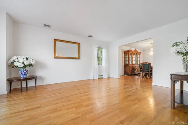 a view of a livingroom with wooden floor and a workspace