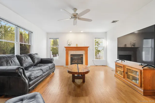 a living room with furniture a fireplace and a flat screen tv