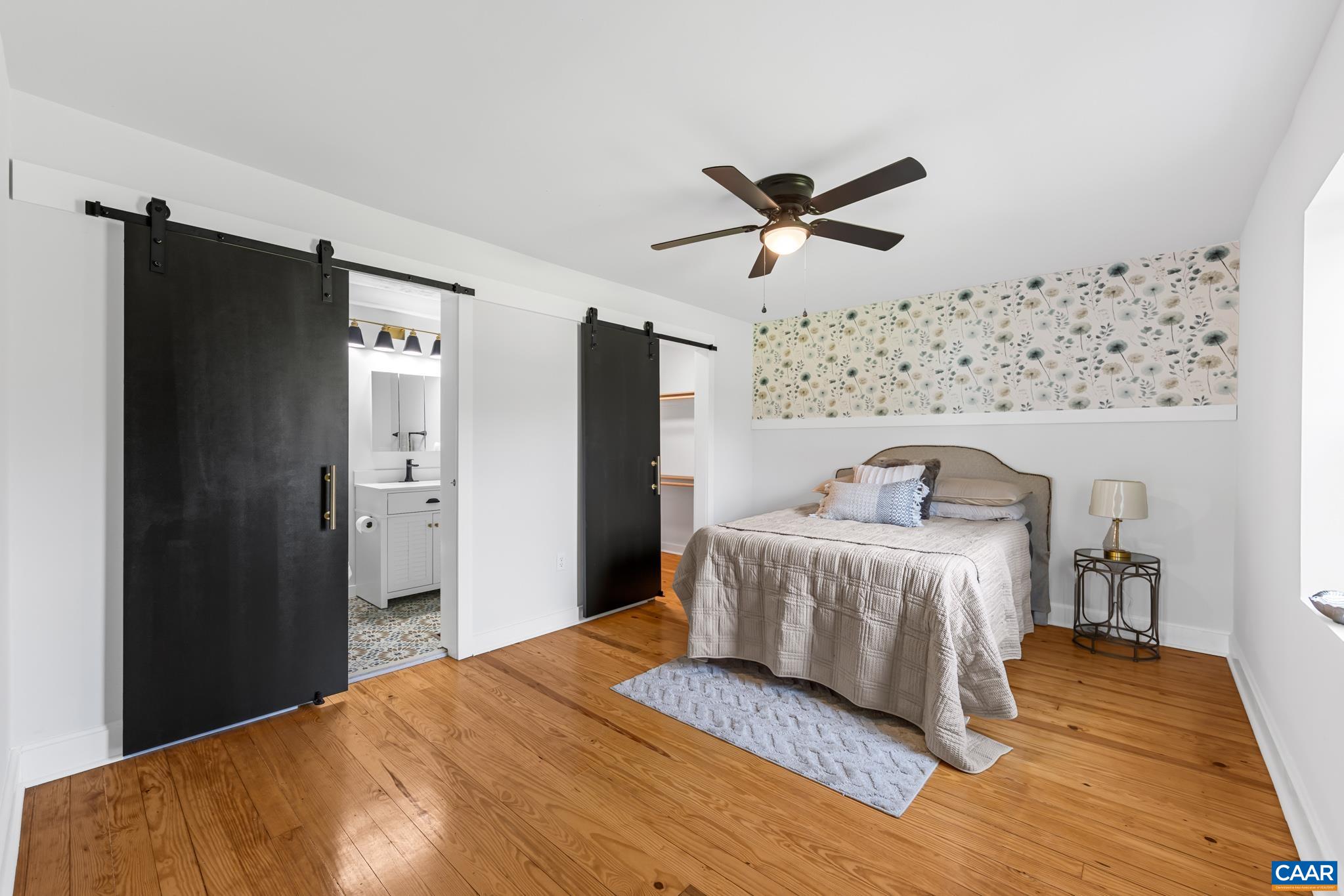 2733 Cedar Lane Road Kents Store, VA 23084 - Photo 25 of 43 A lovely primary suite showcases rich hardwood flooring, a private ensuite bathroom, and ample space for a king size bed. The walk in lighted closet adds both convenience and functionality completing this comfortable 1st floor retreat.