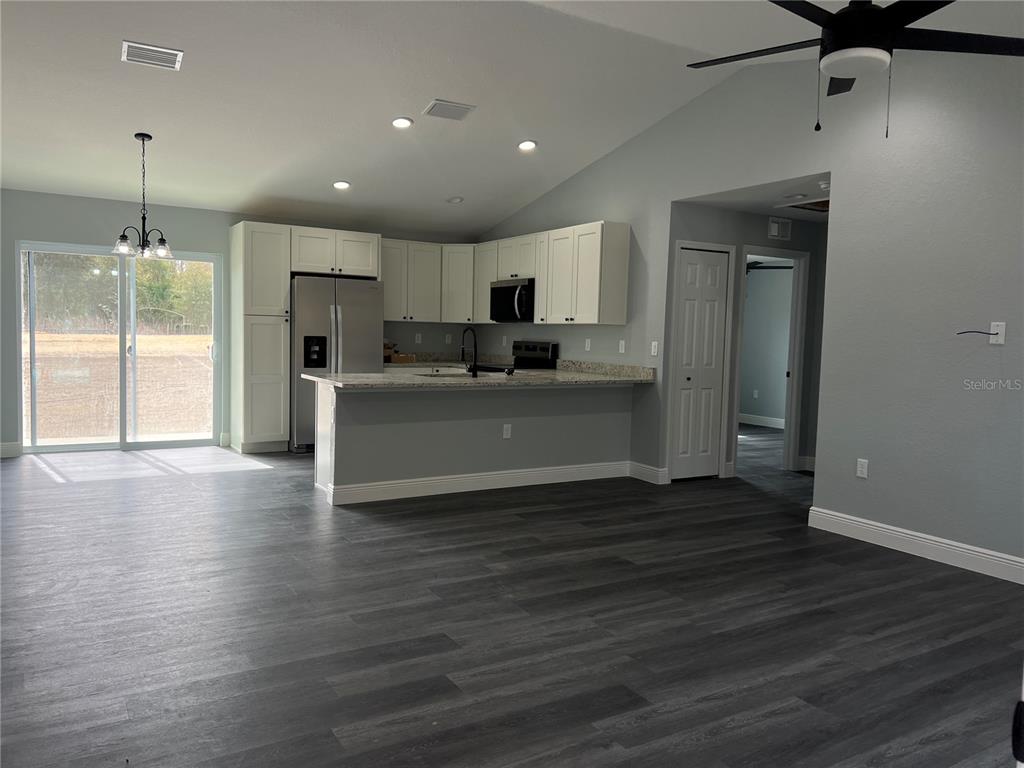 2512 Southwest 147 Place Road Ocala, FL 34473 - Photo 3 of 13 a view of a kitchen with a sink and a refrigerator