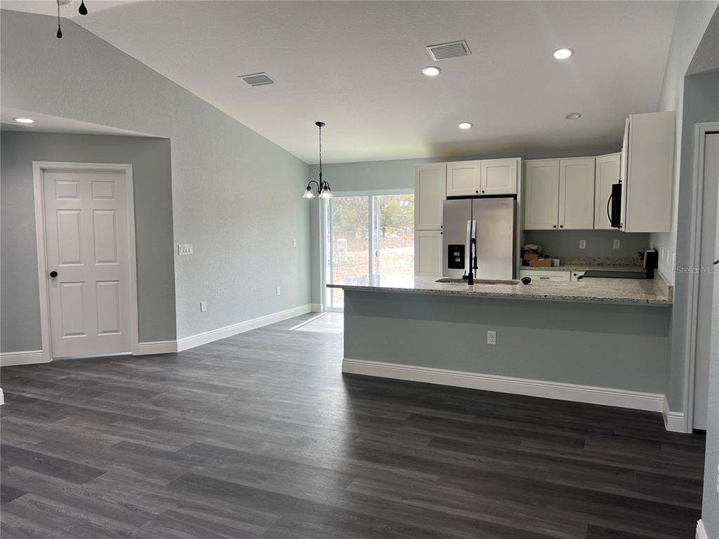 2512 Southwest 147 Place Road Ocala, FL 34473 - Photo 4 of 13 a view of kitchen with wooden floor and window