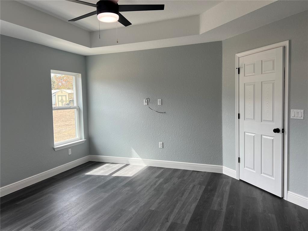 2512 Southwest 147 Place Road Ocala, FL 34473 - Photo 5 of 13 a view of an empty room with wooden floor and a window