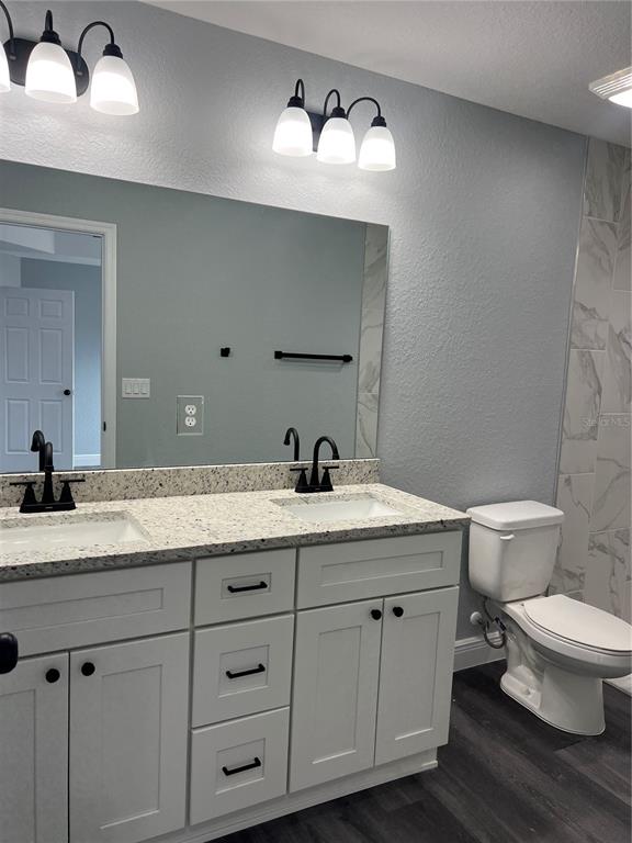 2512 Southwest 147 Place Road Ocala, FL 34473 - Photo 6 of 13 a bathroom with a granite countertop toilet sink and mirror