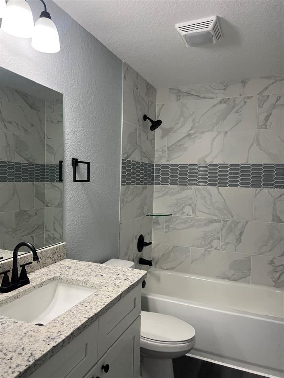 2512 Southwest 147 Place Road Ocala, FL 34473 - Photo 10 of 13 a bathroom with a granite countertop bathtub sink vanity mirror and toilet