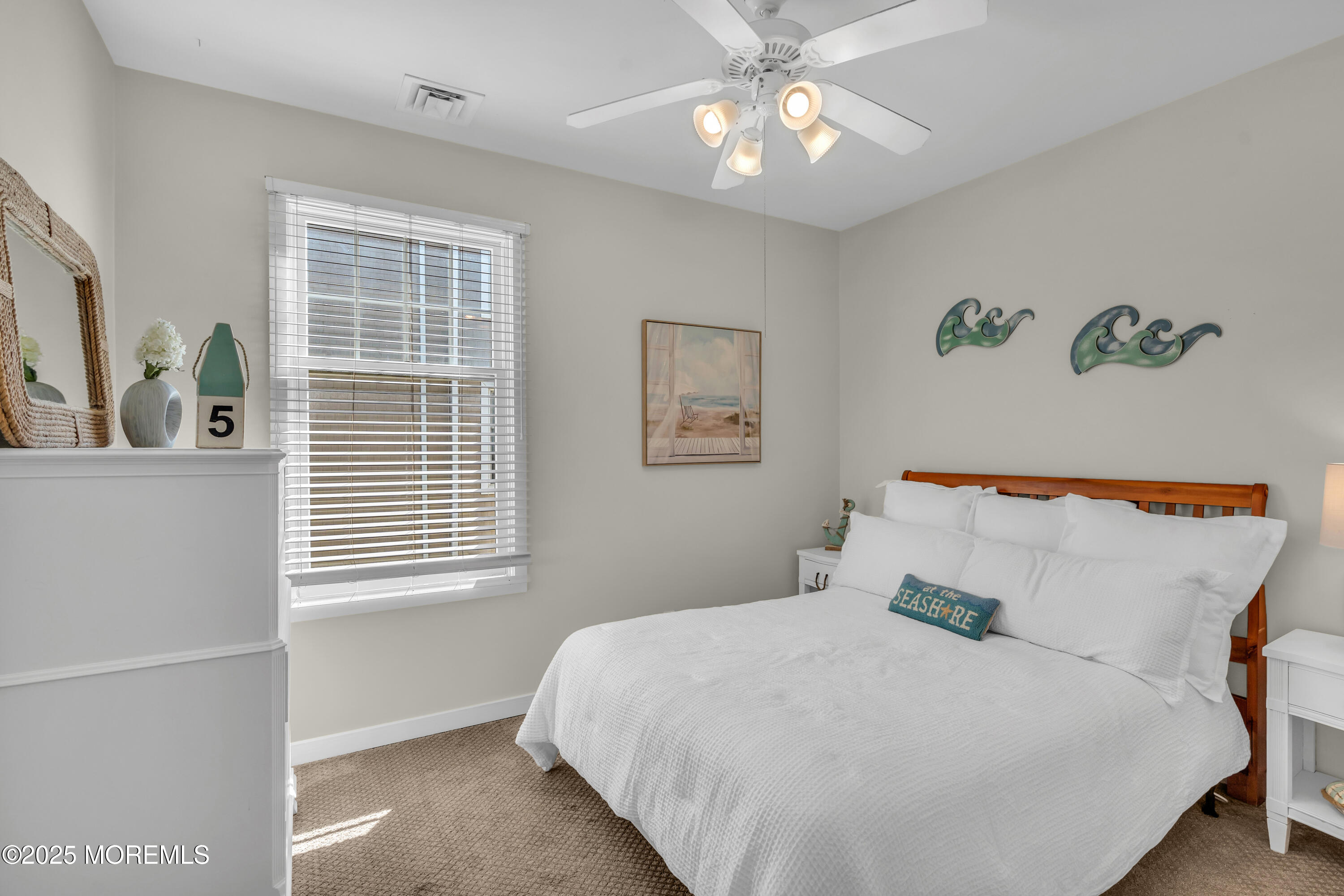 239 Beach Front, Unit 1 Manasquan, NJ 08736 - Photo 14 of 37 a bedroom with a large bed and a window