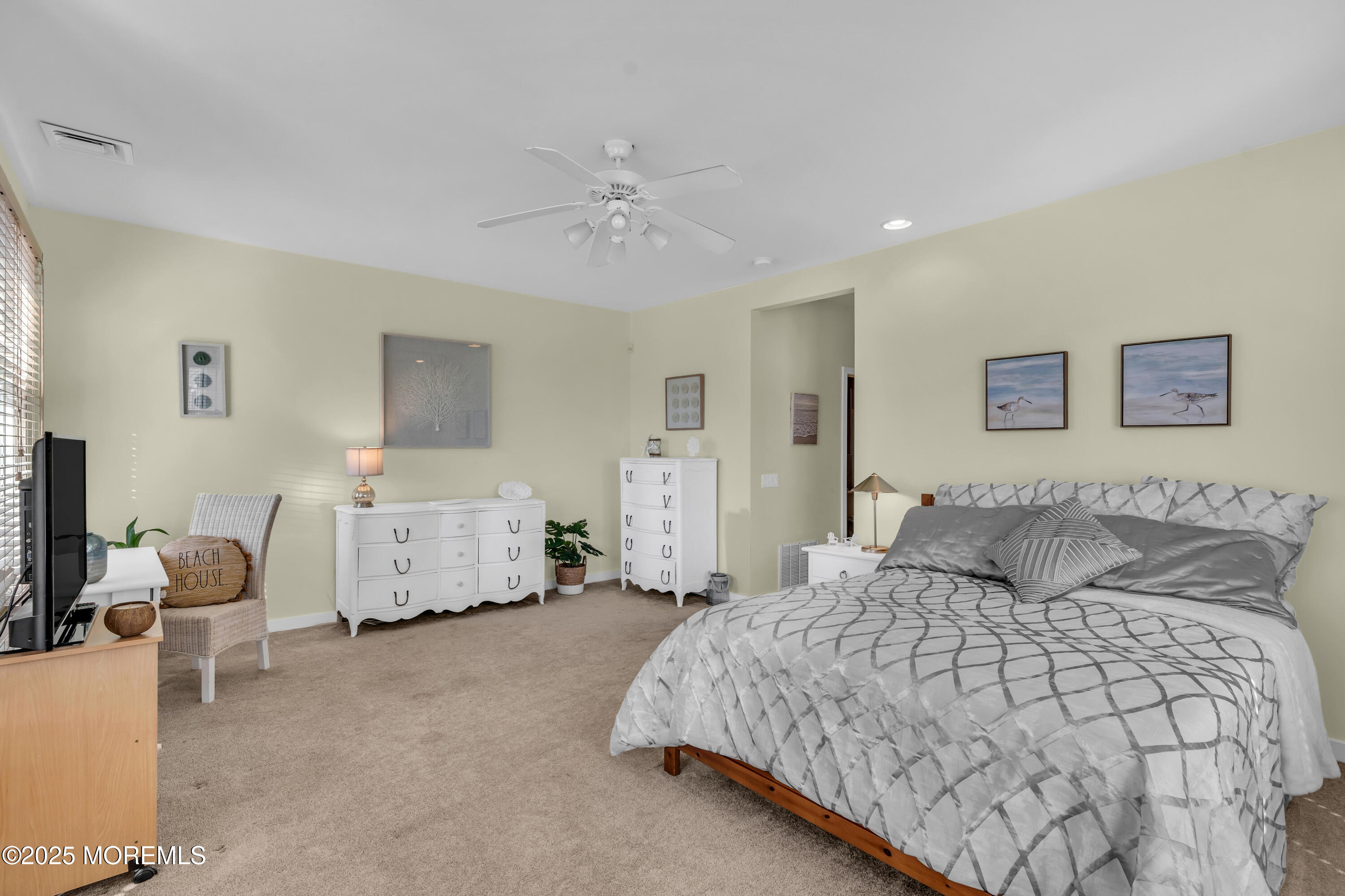 239 Beach Front, Unit 1 Manasquan, NJ 08736 - Photo 19 of 37 a bedroom with a large bed and a chandelier