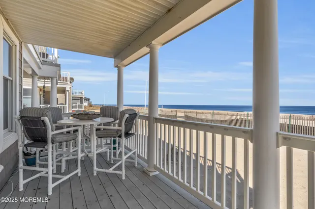 a view of a patio with table and chairs and wooden floor