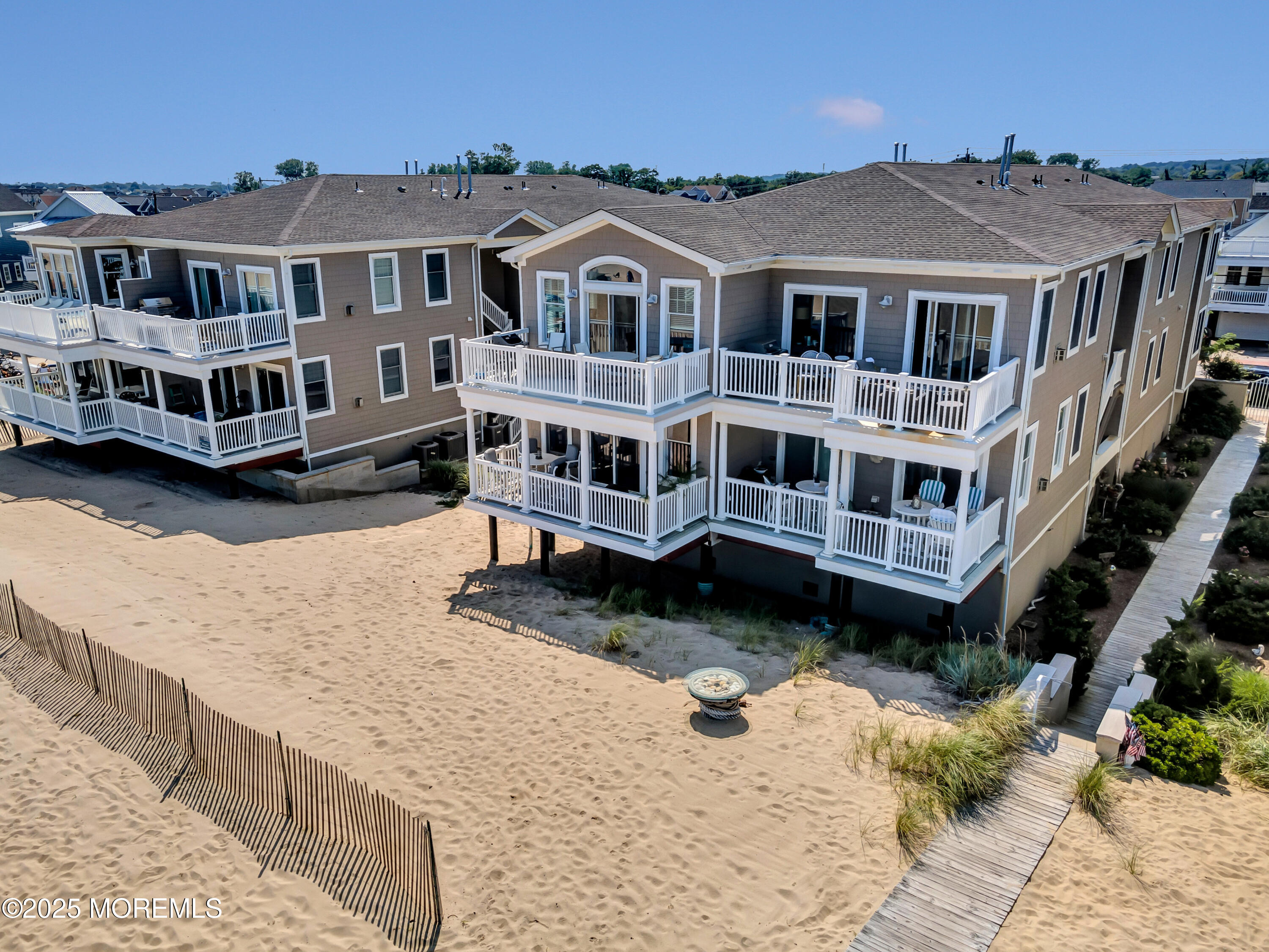 239 Beach Front, Unit 1 Manasquan, NJ 08736 - Photo 26 of 37 a view of a big building with a big yard and large trees