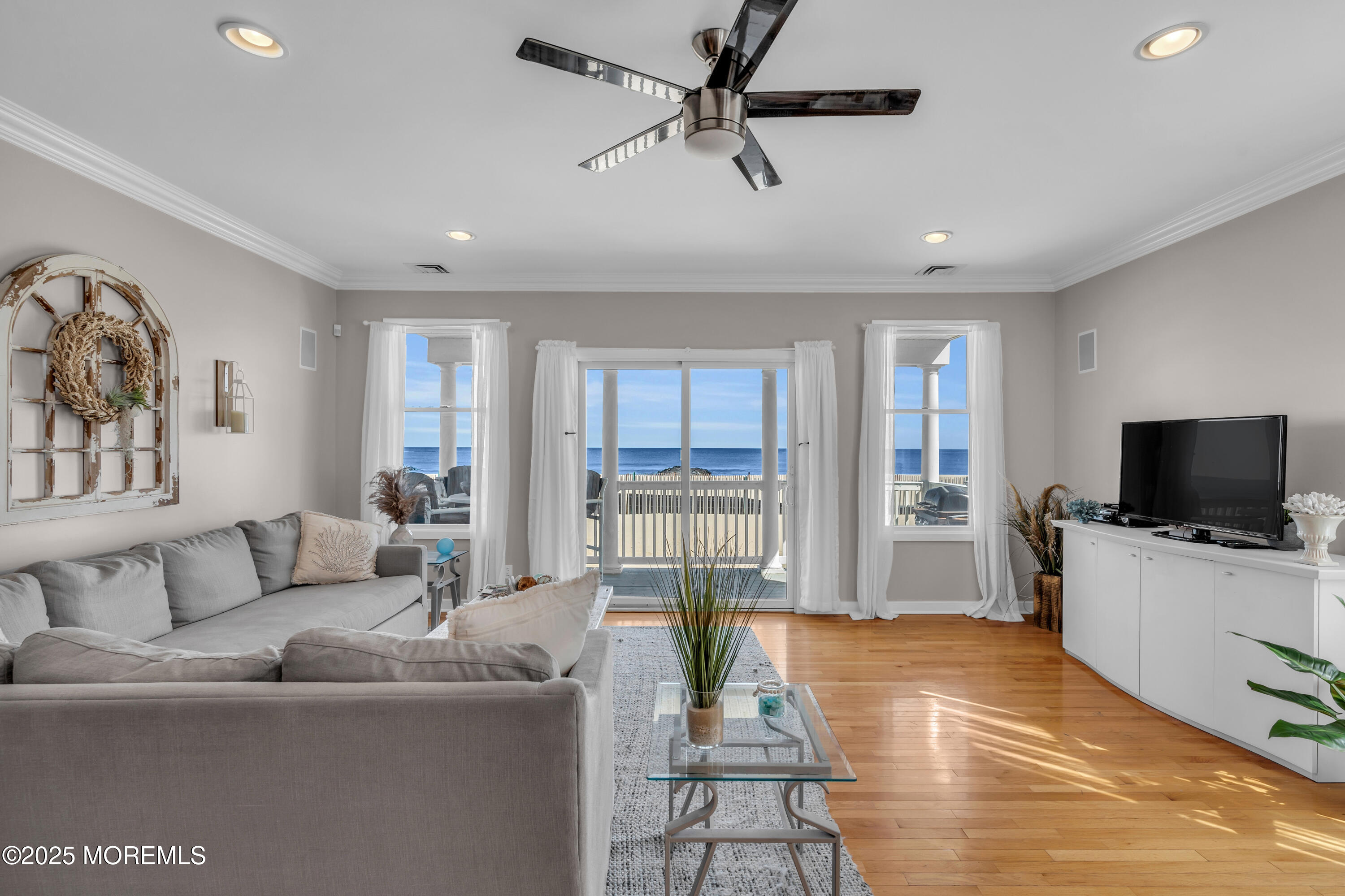 239 Beach Front, Unit 1 Manasquan, NJ 08736 - Photo 4 of 37 a living room with furniture and a flat screen tv