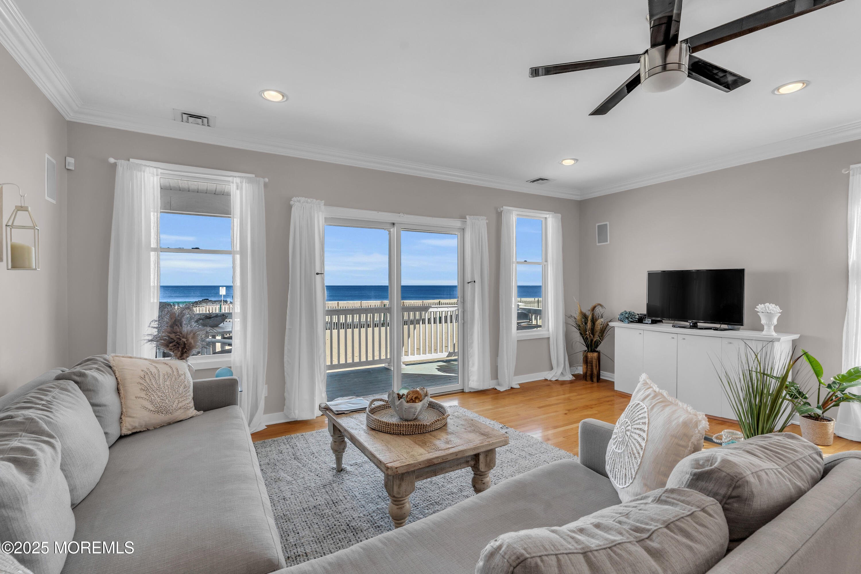 239 Beach Front, Unit 1 Manasquan, NJ 08736 - Photo 5 of 37 a bedroom with furniture and a flat screen tv