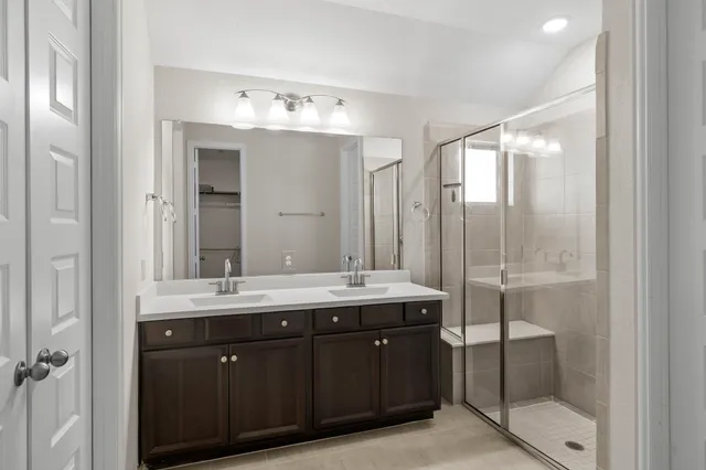 a bathroom with a double vanity sink and mirror