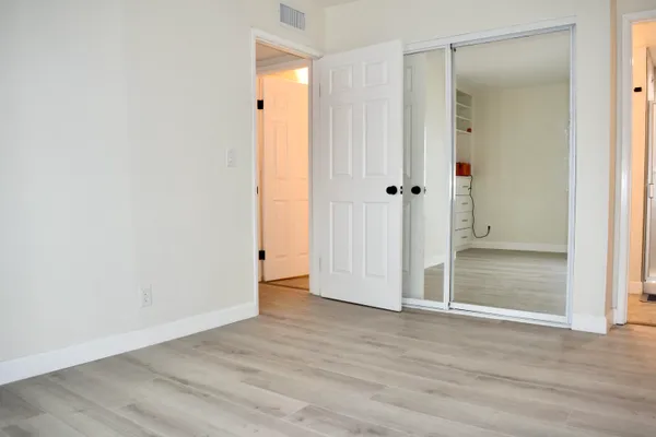 a view of a room with wooden floor
