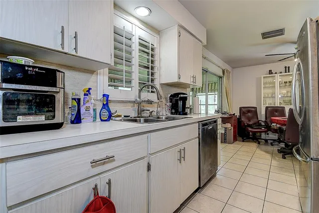 a kitchen with a sink cabinets and a stove top oven