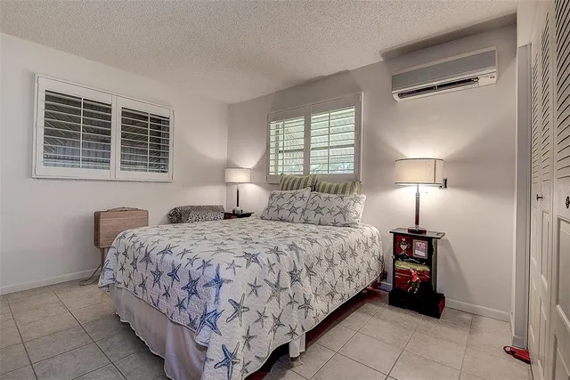 a bedroom with a bed and a lamp