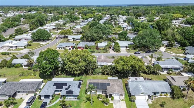 an aerial view of residential houses with outdoor space and street view