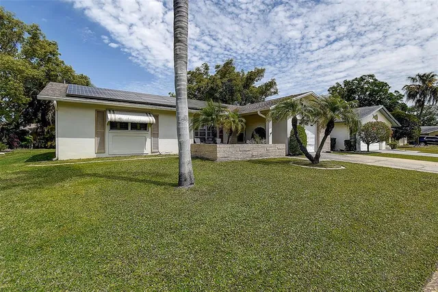 a view of a house with a backyard