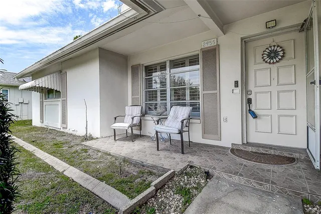 a view of a house with backyard and sitting area