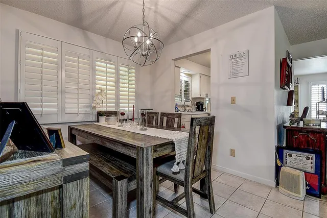 a view of a dining room with furniture and a chandelier