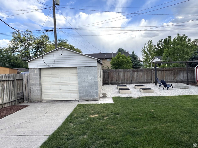 1791 West 170 South, Unit 8 Provo, UT 84601 - Photo 17 of 25 Detached garage with concrete block construction and siding, featuring a single overhead door
