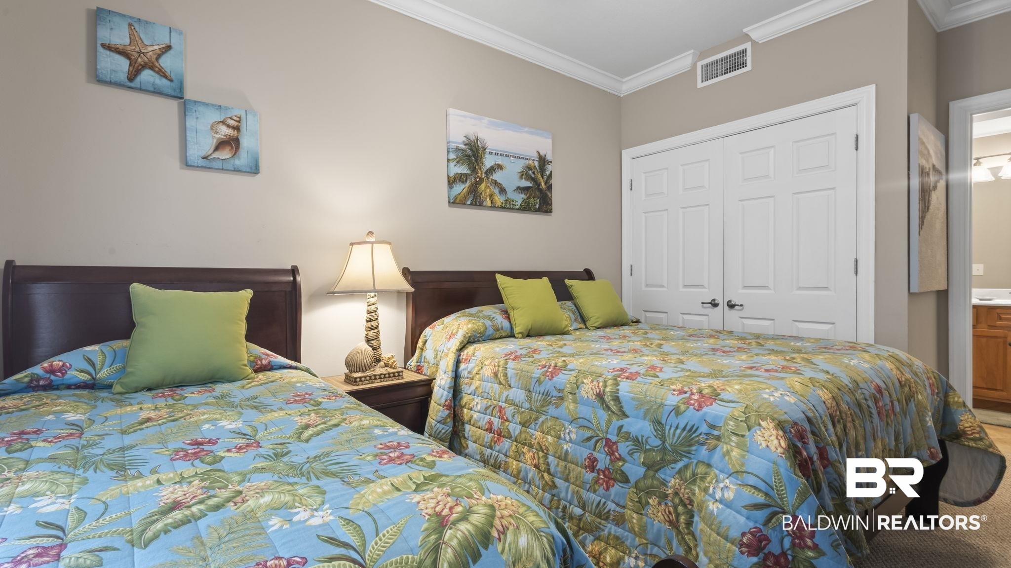 25909 Canal Road, Unit 203 Orange Beach, AL 36561 - Photo 21 of 36 Bedroom with crown molding, a closet, and carpet floors