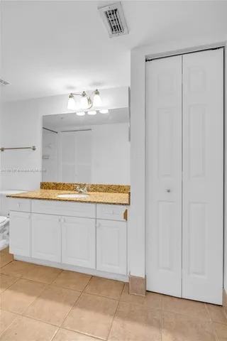 a view of kitchen with granite countertop cabinets and sink
