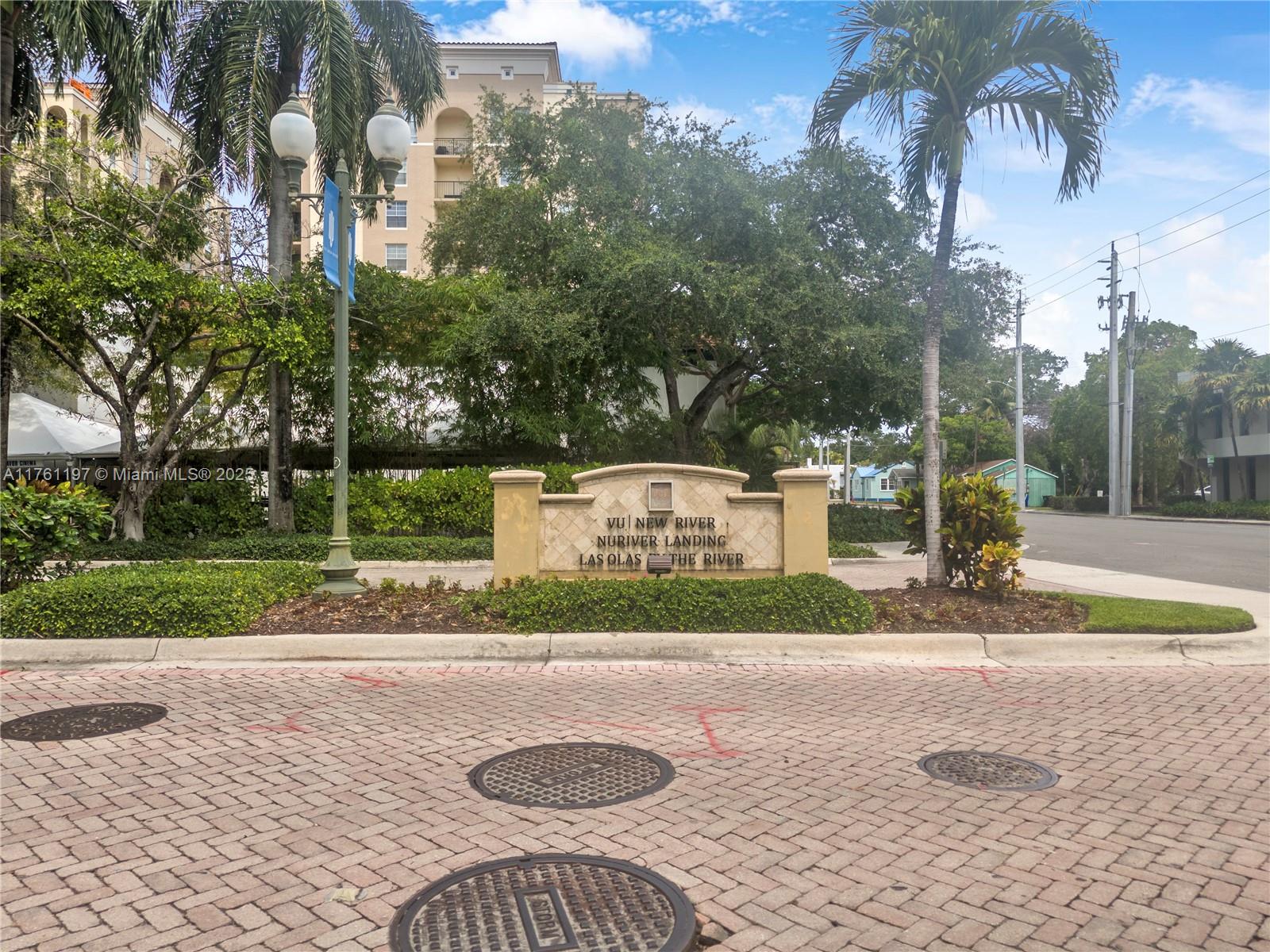 520 Southeast 5th Avenue, Unit 1507 Fort Lauderdale, FL 33301 - Photo 32 of 41 a view of a white house with a yard and large trees
