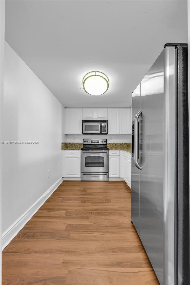 520 Southeast 5th Avenue, Unit 1507 Fort Lauderdale, FL 33301 - Photo 10 of 41 a room with stainless steel appliances wooden floor and view living room