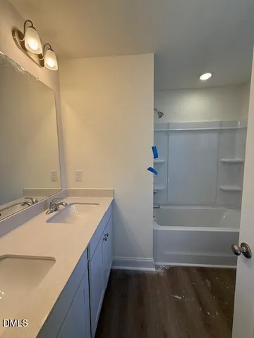 a view of a room with wooden floor