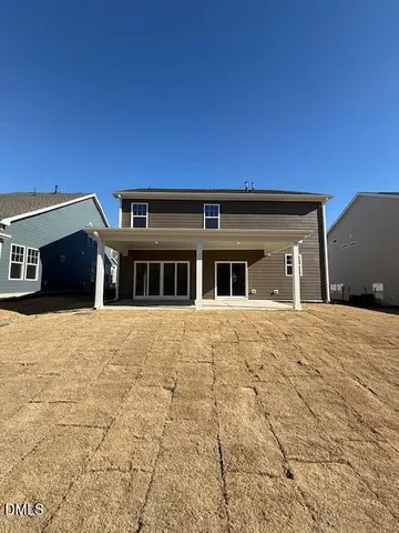 a view of a house with sitting area and swimming pool