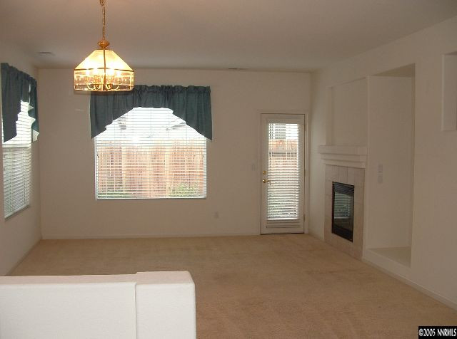 1702 Burwood Circle Reno, NV 89521 - Photo 2 of 9 a view of an empty room with a window and fireplace