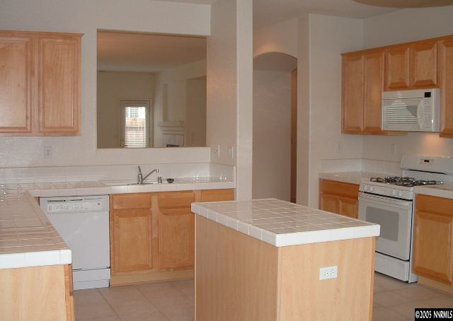 1702 Burwood Circle Reno, NV 89521 - Photo 4 of 9 a kitchen with a sink stove and refrigerator