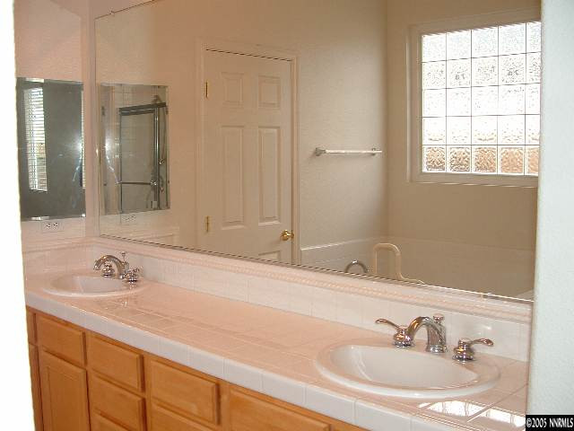 1702 Burwood Circle Reno, NV 89521 - Photo 7 of 9 a bathroom with a sink and a mirror