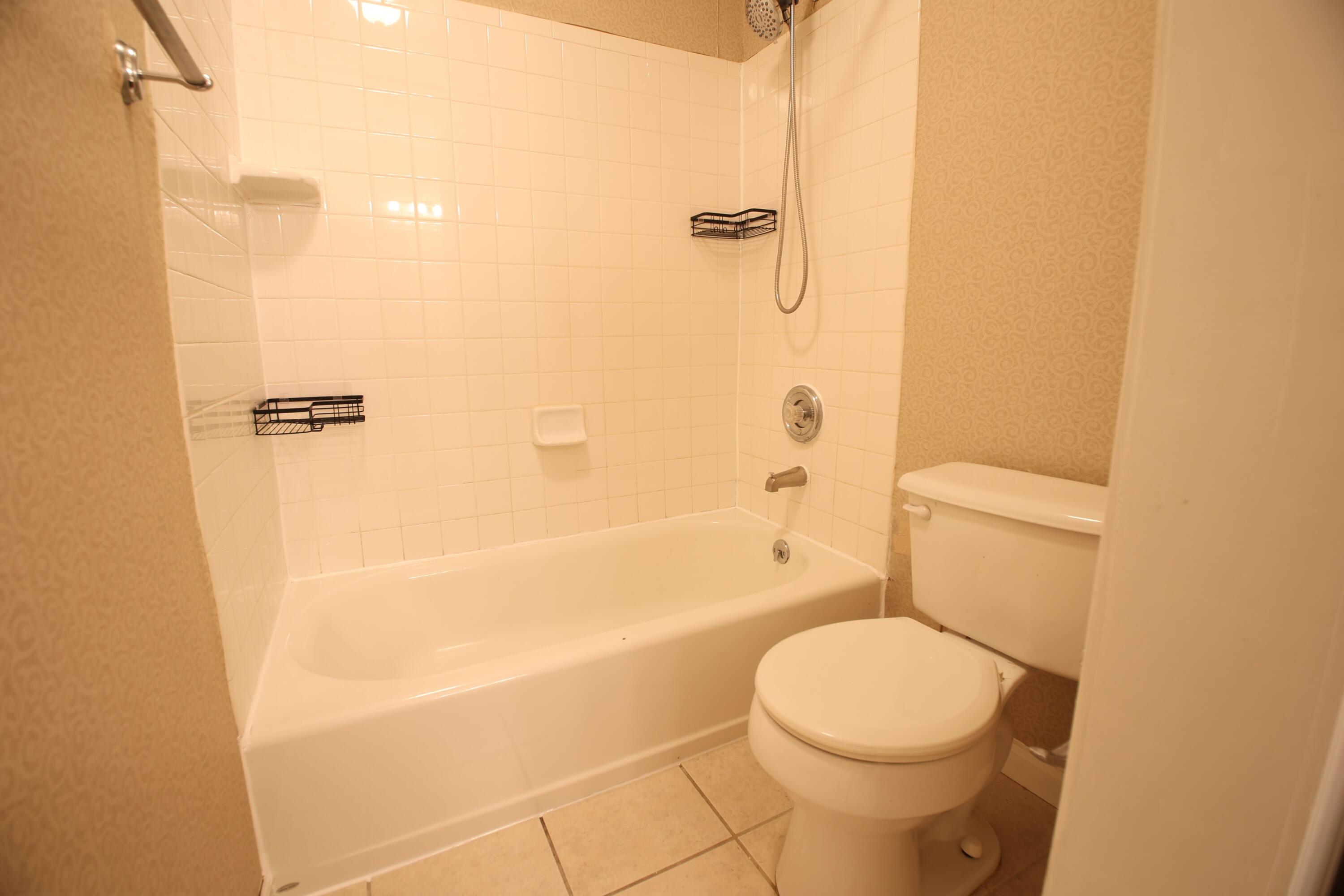 3351 Forest Ridge Road Roanoke, VA 24018 - Photo 7 of 10 a white toilet sitting next to a bath tub