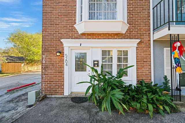 a potted plant sitting in front of a house