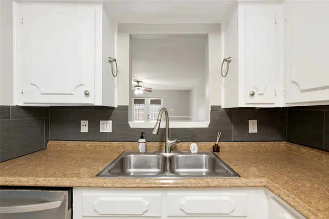 a kitchen with kitchen island a sink and a counter top space