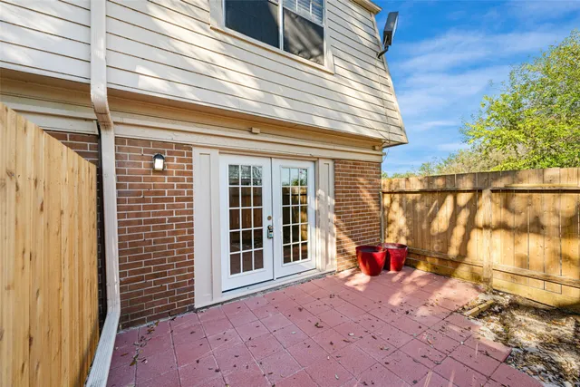 a balcony with table and chairs