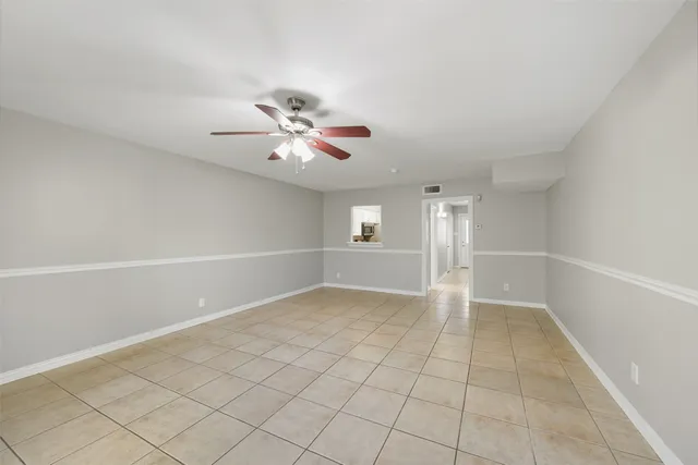 an empty room with a empty space and windows