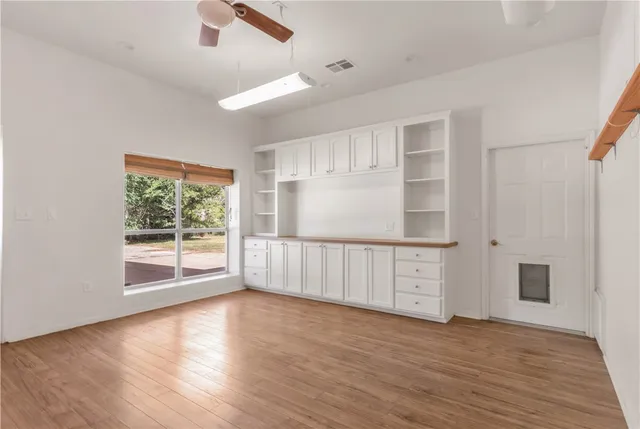 a view of a kitchen with sink and wooden floor