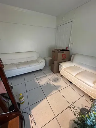 a kitchen with a stove and white cabinets