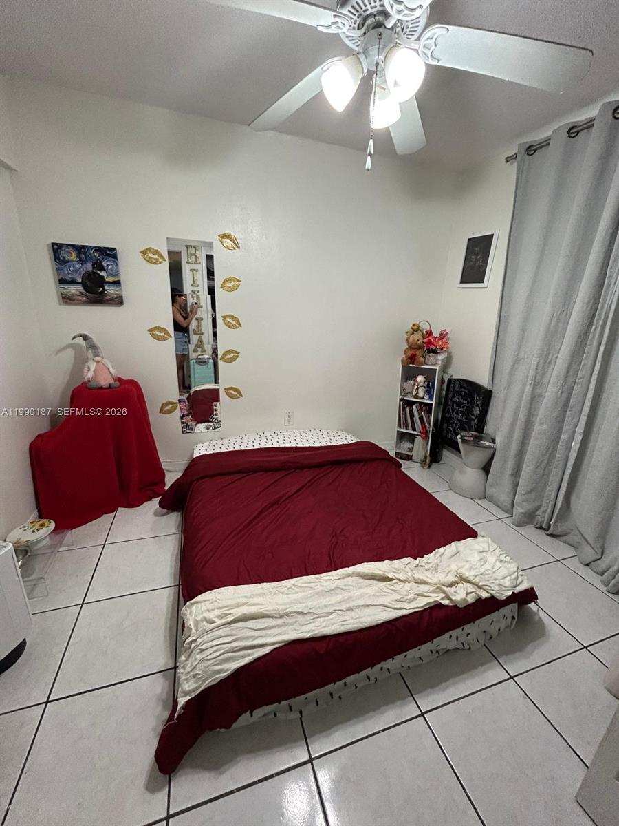 11 Southwest 32nd Avenue, Unit 4 Miami, FL 33135 - Photo 6 of 10 a bedroom with a bed and a chandelier