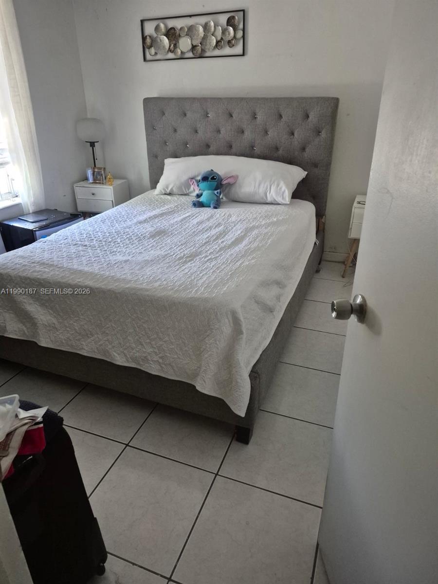 11 Southwest 32nd Avenue, Unit 4 Miami, FL 33135 - Photo 8 of 10 a bedroom with a bed and a window