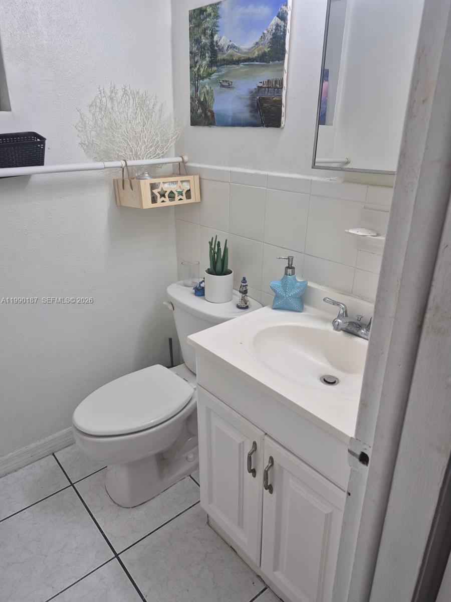 11 Southwest 32nd Avenue, Unit 4 Miami, FL 33135 - Photo 9 of 10 a bathroom with a sink and mirror