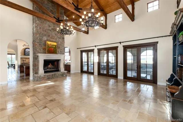a view of an empty room with a fireplace and a window