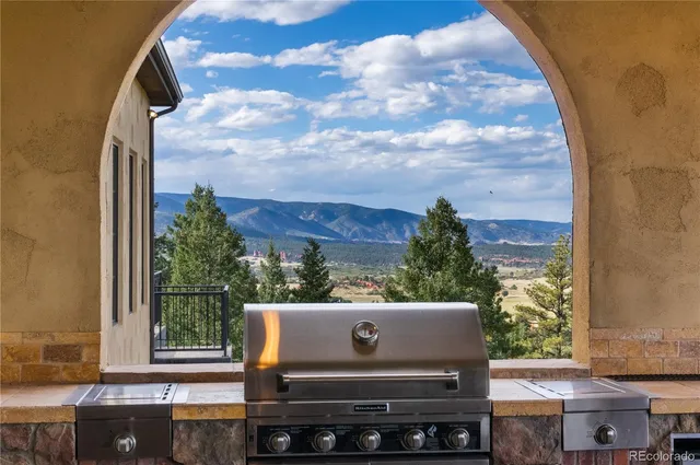 a view of a balcony with a couple of cars parked in parking lot