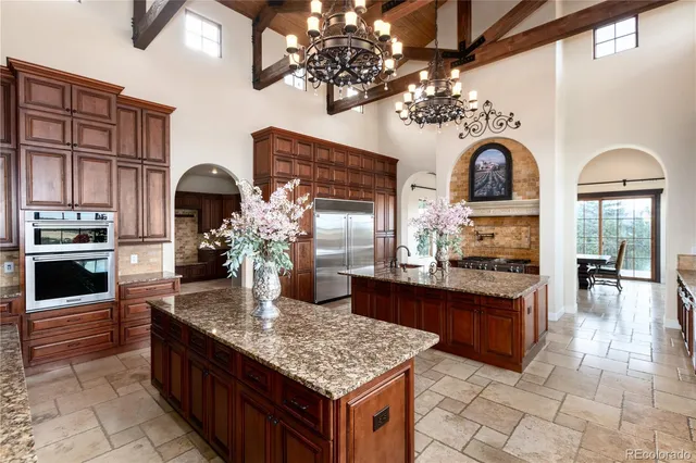 a kitchen with stainless steel appliances granite countertop a stove refrigerator and cabinets