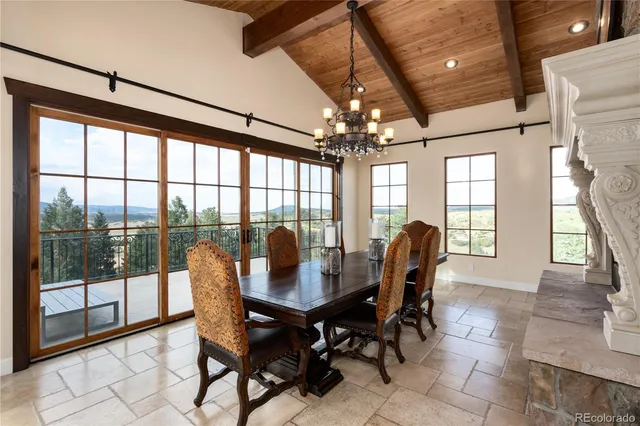 a dining room with furniture a chandelier and wooden floor
