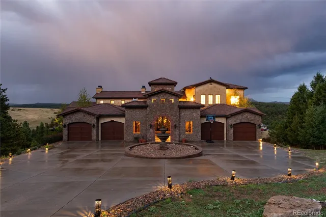 a front view of a house with a garden and a yard